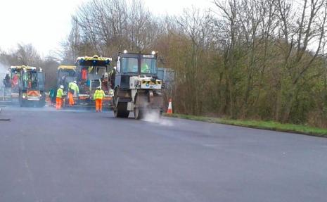 image of concrete paving machine laying new road surface